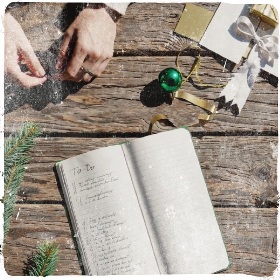 a to-do list on a festive table wih a woman's hands