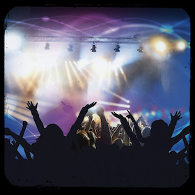 crowd cheering at an indoor concert